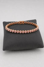 Heart Bezel Tennis Bracelet — Rose-gold-tone with clear/pink heart stones — on a display cushion