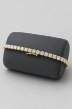 6mm Tennis Bracelet — Gold-tone 6mm tennis bracelet — on a display cushion